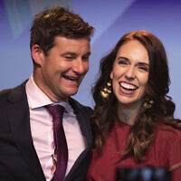 In this Oct. 17, 2020, file photo, New Zealand Prime Minister Jacinda Ardern, right, is congratulated by her partner Clarke Gayford following her victory speech to Labour Party members at an event in Auckland, New Zealand (AP Photo/Mark Baker, File)