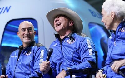 Mark Bezos, left, Jeff Bezos, center, founder of Amazon and space tourism company Blue Origin, and Wally Funk, right, make comments during a post launch news briefing from its spaceport near Van Horn, Texas, Tuesday, July 20, 2021. (AP Photo/Tony Gutierrez)
