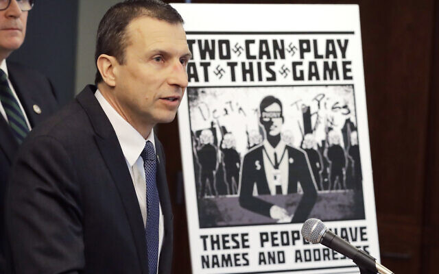 FILE - In this Feb. 26, 2020, file photo, Raymond Duda, special agent in charge in Seattle, speaks as he stands next to a poster that was mailed earlier in the year to the home of Chris Ingalls, an investigative reporter with KING-TV in Seattle, during a news conference in Seattle. A federal jury in Seattle on Wednesday, Sept. 29, 2021, convicted Kaleb Cole, a leader of a neo-Nazi campaign to threaten journalists and Jewish activists in three states. Cole and three others were charged last year with having sent Swastika-laden posters to journalists and people affiliated with the Anti-Defamation League in Washington, Florida and Arizona.  (AP Photo/Ted S. Warren, File)