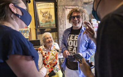 Sandra Jaffe, who along with her husband, Allan, owned and managed Preservation Hall since the early 1960s, stands with her son, Ben, as they greet guests to the first show at the historic venue in 15 months since the coronavirus lockdown, Thursday, June 10, 2021, in New Orleans. The guest, right, crosses his fingers in the hope that music and touring will be back for good. (Chris Granger/The Times-Picayune/The Advocate via AP)