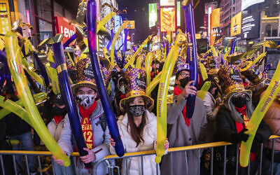 Revellers gather during the New Year's Eve celebrations in Times Square on Dec. 31, 2021, in New York. (AP Photo/Jeenah Moon)