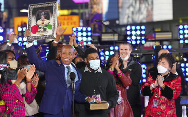 Eric Adams holds up a framed image of his mother at his swearing-in as New York mayor at the Times Square New Year's Eve celebration early Jan. 1, 2022, in New York. (Ben Hider/Invision/AP)