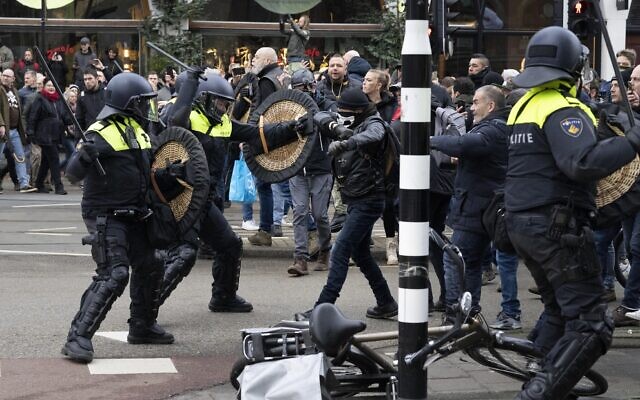 Police clash with demonstrators as thousands of people defied a ban to gather and protest the Dutch government's coronavirus lockdown measures, in Amsterdam, Netherlands, January 2, 2022. (AP Photo/Peter Dejong)