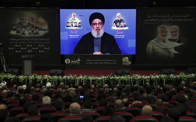 Hezbollah leader Sayyed Hassan Nasrallah speaks via a video link during a ceremony to mark the second anniversary of the assassination of the head of Iran's Quds Force ,General Qassem Soleimani, in the southern Beirut suburb of Dahiyeh, Lebanon, January 3, 2022. (AP Photo/Bilal Hussein)