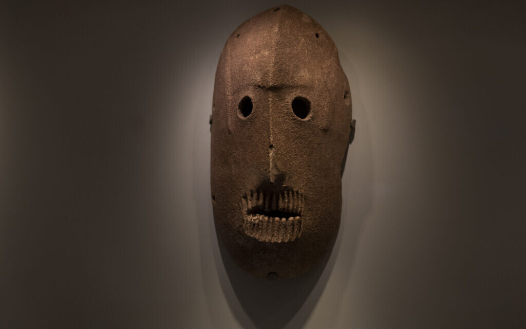 A Neolithic mask loaned by American billionaire Michael Steinhardt, is displayed at the Israel Museum in Jerusalem, Wednesday, Jan. 5, 2022. Last month, Steinhardt surrendered the artifact, along with 179 others as part of a landmark deal with the Manhattan District Attorney's office to avoid prosecution.  (AP Photo/Maya Alleruzzo)