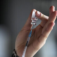 Illustrative: A medical student prepares a syringe with vaccination against COVID-19 in Berlin, Germany, January 5, 2022. (AP Photo/Markus Schreiber)