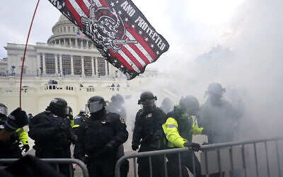 Police hold off violent insurrections loyal to then-US president Donald Trump as they try to break through a police barrier at the Capitol in Washington, DC, on January 6, 2021. (Julio Cortez/AP)