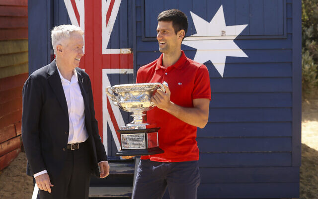 Serbia's Novak Djokovic, right, stands with Australian Open tournament director Craig Tiley for a trophy photo shoot following his win the Australian Open tennis championships in Melbourne, Australia, February 22, 2021. (AP Photo/Hamish Blair)