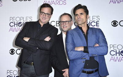 Bob Saget, from left, Dave Coulier and John Stamos, winners of the award for favorite premium comedy series for "Fuller House," pose in the press room at the People's Choice Awards at the Microsoft Theater on Wednesday, Jan. 18, 2017, in Los Angeles. (Photo by Jordan Strauss/Invision/AP, File)