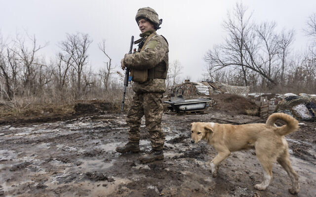 A Ukrainian soldier walks on the line of separation from pro-Russian rebels, Donetsk region, Ukraine, January 10, 2022 (AP Photo/Andriy Dubchak)