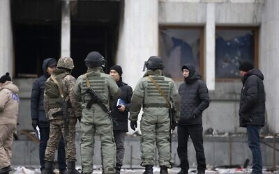 Servicemen guard an entrance of the city hall building after clashes in the central square in Almaty, Kazakhstan, Jan. 10, 2022. (Vasily Krestyaninov/AP)