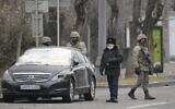 Kazakhstan troops and police block a street in Almaty, Kazakhstan, Jan. 10, 2022. (AP Photo)