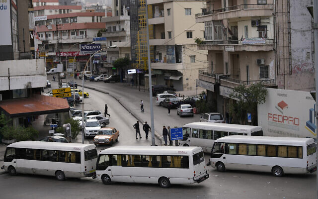 Buses block a road during a general strike by public transport and labor unions to protest Lebanon's deteriorating economic and financial conditions, in the capital Beirut, on January 13, 2022. (AP Photo/Hussein Malla)