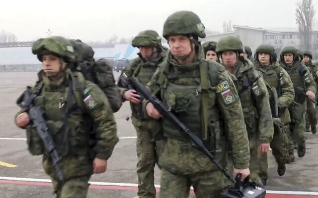 In this image taken from video released by Russian Defense Ministry Press Service, Russian peacekeepers of the Collective Security Treaty Organization board a Russian military plane starting to withdraw its troops at an airport outside Almaty, Kazakhstan,  on January 13, 2022. (Russian Defense Ministry Press Service via AP)