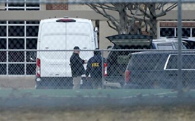 Law enforcement officials gather at Colleyville Elementary School near the Congregation Beth Israel synagogue on Saturday, Jan. 15, 2022 in Colleyville, Texas. (AP Photo/Tony Gutierrez)