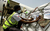 A shipment of COVID-19 vaccines distributed by the COVAX Facility arrives in Abidjan, Ivory Coast, Friday Feb. 25, 2021. (AP Photo/Diomande Ble Blonde)