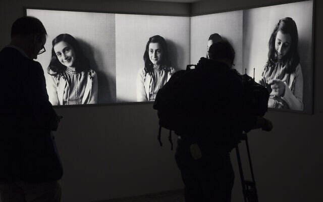 A journalist takes images of pictures of Anne Frank at the renovated Anne Frank House Museum in Amsterdam, Netherlands, November 21, 2018. (AP Photo/ Peter Dejong, File)