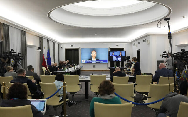A Polish Senate commission hears the testimony of two cybersecurity experts, John Scott-Railton and Bill Marczak, senior researchers with the Citizen Lab, a research group based at the University of Toronto, in Warsaw, Poland, on January 17, 2022. (AP Photo/Czarek Sokolowski)