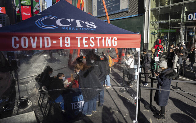 People wait in line at COVID-19 testing site in Times Square, on December 3, 2021, in New York. (AP Photo/Yuki Iwamura, File)