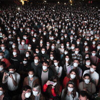 People wearing face masks attend a music concert in Barcelona, Spain, March 27, 2021. (AP Photo/Emilio Morenatti, File)