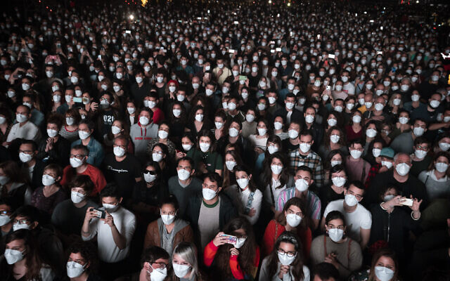 People wearing face masks attend a music concert in Barcelona, Spain, March 27, 2021. (AP Photo/Emilio Morenatti, File)