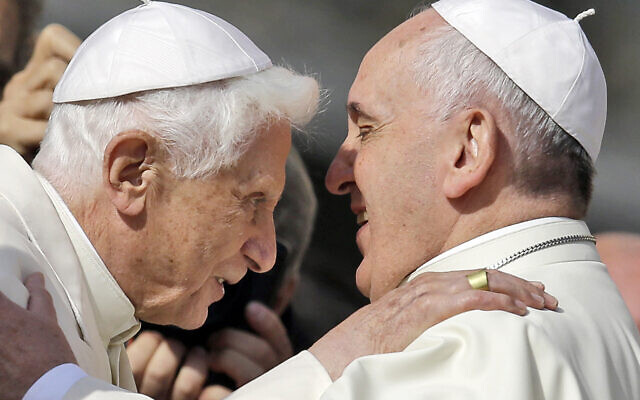 Pope Francis (right) hugs Pope Emeritus Benedict XVI prior to the start of a meeting with elderly faithful in St. Peter's Square at the Vatican, on Sunday, September 28, 2014. (AP Photo/Gregorio Borgia, File)