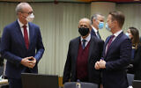 Ireland's Foreign Minister Simon Coveney, left,, speaks with Cypriot Foreign Minister Ioannis Kasoulides, center, and Denmark's Foreign Minister Jeppe Kofod during a meeting of EU foreign ministers at the European Council building in Brussels on Jan. 24, 2022. (AP Photo/Virginia Mayo)