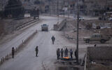 Fighters with the Kurdish-led Syrian Democratic Forces man a checkpoint in Hassakeh, northeast Syria, Monday, Jan. 24, 2022. (AP Photo/Baderkhan Ahmad)