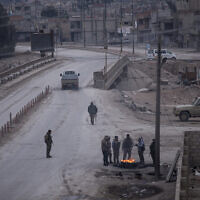 Fighters with the Kurdish-led Syrian Democratic Forces man a checkpoint in Hassakeh, northeast Syria, Monday, Jan. 24, 2022. (AP Photo/Baderkhan Ahmad)