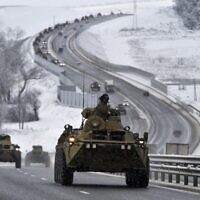A convoy of Russian armored vehicles moves along a highway in Crimea, Jan. 18, 2022. (AP Photo)