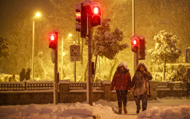 Pedestrians walk during a snowfall in Istanbul, Turkey, on Jan. 24, 2022. (Emrah Gurel/AP)
