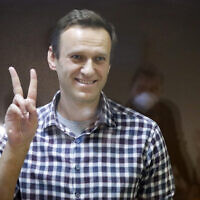 Russian opposition leader Alexei Navalny gestures as he stands in a cage in the Babuskinsky District Court in Moscow, Russia, Saturday, Feb. 20, 2021. (AP/Alexander Zemlianichenko, File)