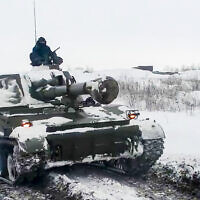 In this photo taken from video provided by the Russian Defense Ministry Press Service on January 26, 2022, a Russian self-propelled gun rolls during a military exercising at a training ground in Rostov region, Russia. (Russian Defense Ministry Press Service via AP)