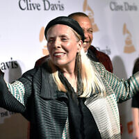 Joni Mitchell arrives at the 2015 Clive Davis Pre-Grammy Gala in Beverly Hills, Calif. Feb. 7, 2015. Joni Mitchell said Friday, Jan. 28, 2022 she seeks to remove all of her music in Spotify in solidarity with Neil Young, who ignited a protest against the streaming service for airing a podcast that featured a figure who has spread misinformation about the coronavirus. (John Shearer/Invision/AP, File)