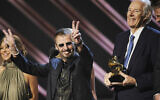 In this February 10, 2008, file photo, former Beatle Ringo Starr, center, and Beatles producer Sir George Martin accept the best compilation soundtrack album award for 'Love' during the 50th annual Grammy awards held at the Staples Center in Los Angeles. (AP Photo/Kevork Djansezian, File)