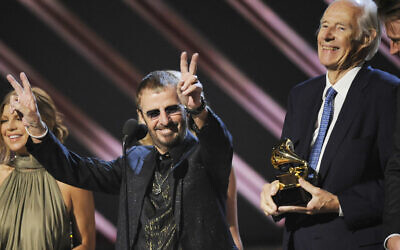 In this February 10, 2008, file photo, former Beatle Ringo Starr, center, and Beatles producer Sir George Martin accept the best compilation soundtrack album award for 'Love' during the 50th annual Grammy awards held at the Staples Center in Los Angeles. (AP Photo/Kevork Djansezian, File)