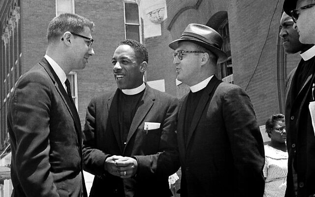 Three of 10 freedom riders on trial at Tallahassee, Florida, for unlawful assembly confer during a court recess on June 22, 1961. Talking are (from left) Rabbi Israel Dresner, the Rev. A.L. Hardge and the Rev. Robert Storm. (AP Photo)