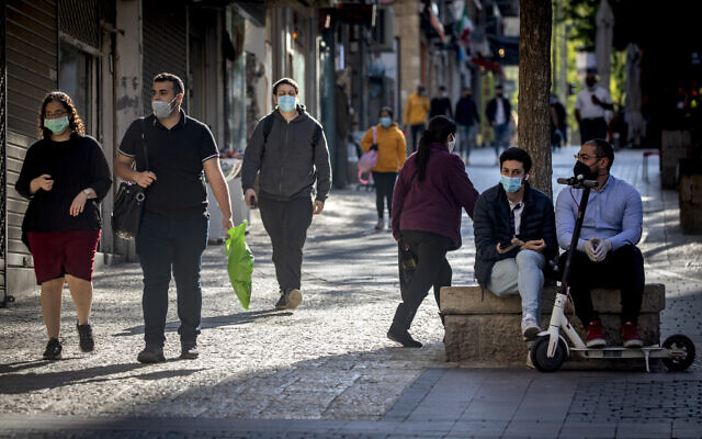 People wear protective face masks in Jerusalem, April 30, 2020. (Olivier Fitoussi/Flash90)