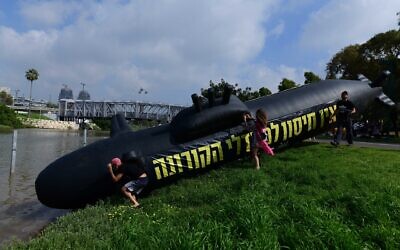 Israelis place rubber submarines in the Yarkon river as part of a protest against then-prime minister Benjamin Netanyahu, in Tel Aviv on February 12, 2021. (Tomer Neuberg/Flash90)