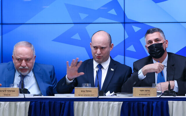 Prime Minister Naftali Bennett, Minister of Justice Gideon Sa'ar (right), and Finance Minister Avigdor Liberman (left), hold a press conference in the Prime Minister's Office on July 6, 2021.  (Amit Shabi/POOL)