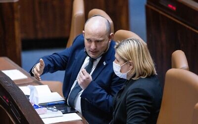 Prime Minister Naftali Bennett speaks with Economy and Industry Minister Orna Barbivai at the Knesset on October 11, 2021. (Yonatan Sindel/Flash90)