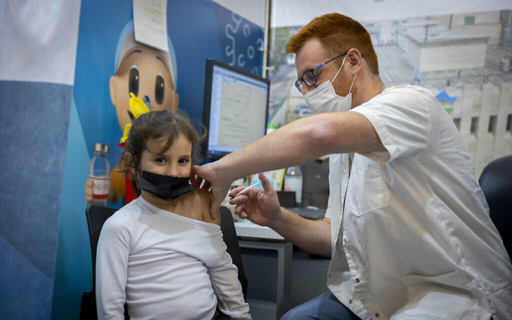 A child receives a dose of COVID-19 vaccine in Jerusalem on December 30, 2021 (Olivier Fitoussi/Flash90)