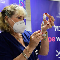 Health care staff receive a 4th dose of the Moderna COVID-19 vaccine, at the Sheba Medical Center on January 5, 2022. (Avshalom Sassoni/Flash90)