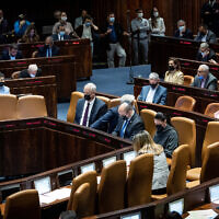 Illustrative: Ministers and MKs attend a plenum session in the assembly hall of the Knesset in Jerusalem, January 5, 2022.(Yonatan Sindel/Flash90)