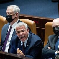 Yair Lapid, center, yells during a Knesset debate in Jerusalem on January 5, 2022. (Yonatan Sindel/Flash90)