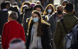 People, some wearring face masks, walk on Jaffa Street in Jerusalem, on January 6, 2022. (Olivier Fitoussi/Flash90)