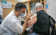 Israelis receive a dose of the COVID-19 vaccine at a temporary Maccabi health care center in Rehovot, on January 10, 2022. (Yossi Aloni/Flash90)