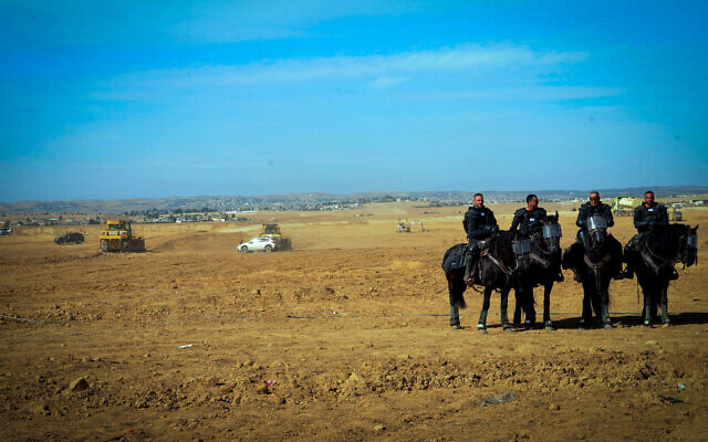 Illustrative: Police officers outside the Bedouin village of Mulada in the Negev desert, southern Israel, January 12, 2022. (Flash90)