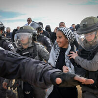 Israeli police officers guard outside the Bedouin village of Mulada, in the Negev on January 12, 2022. (Flash90)