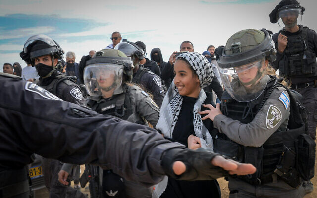 Israeli police officers guard outside the Bedouin village of Mulada, in the Negev on January 12, 2022. (Flash90)